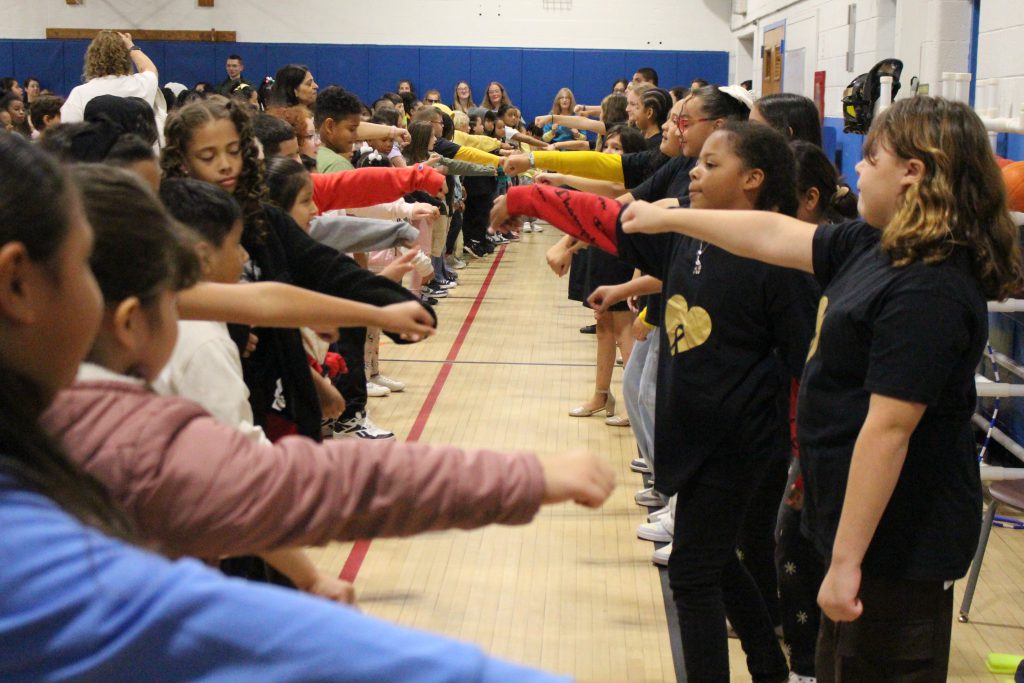 students are dancing at the front of the stage