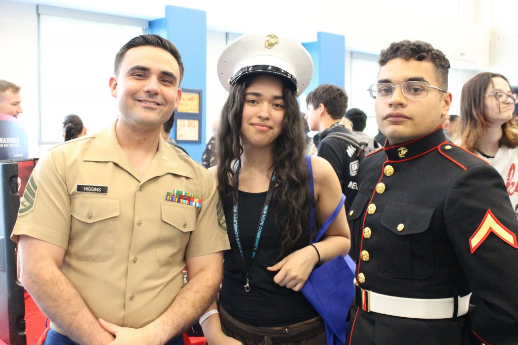 a female student is posing with two Marine corps 