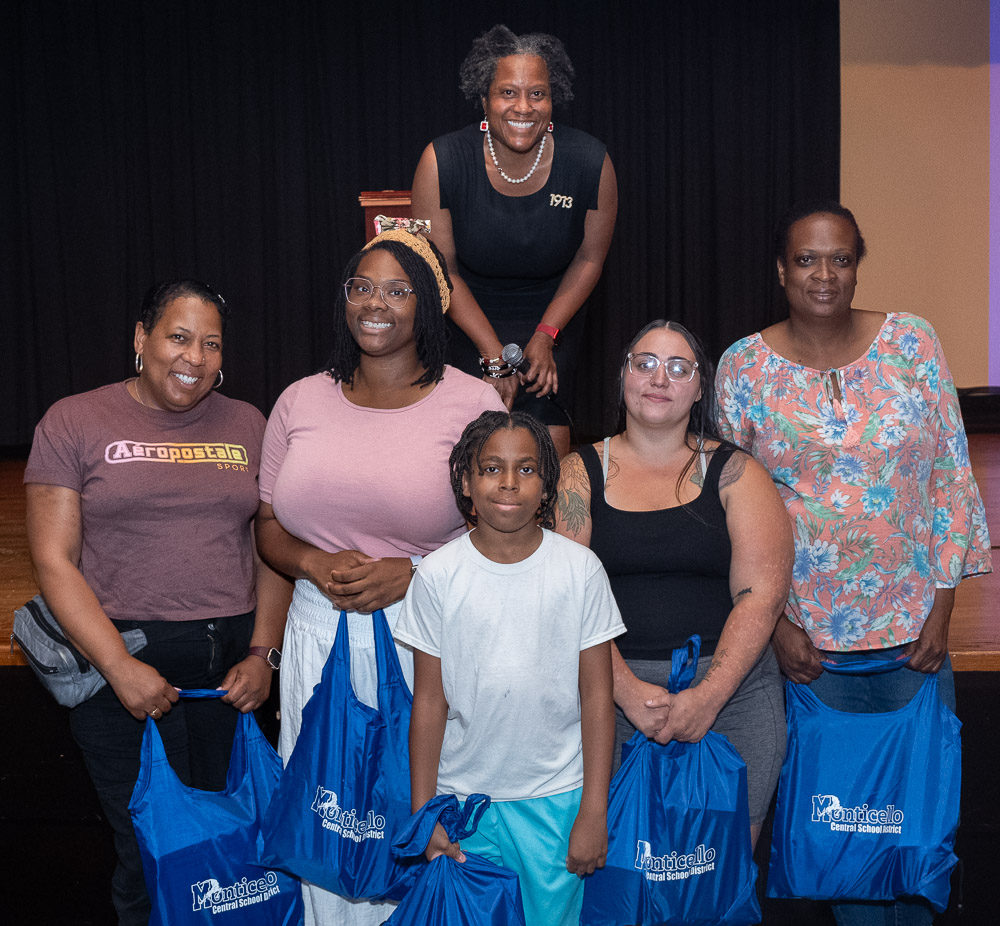 a group of people are smiling and holding prizes