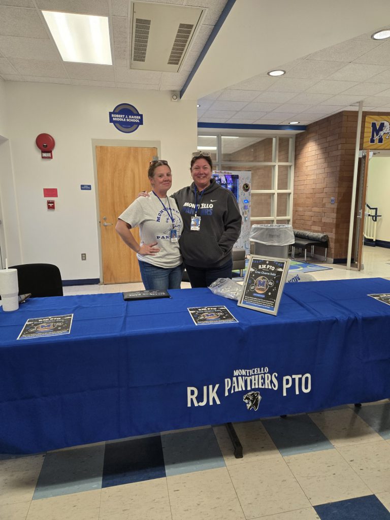 Melinda Gwiozdowski and Meghan Stalter are posing behind a table 