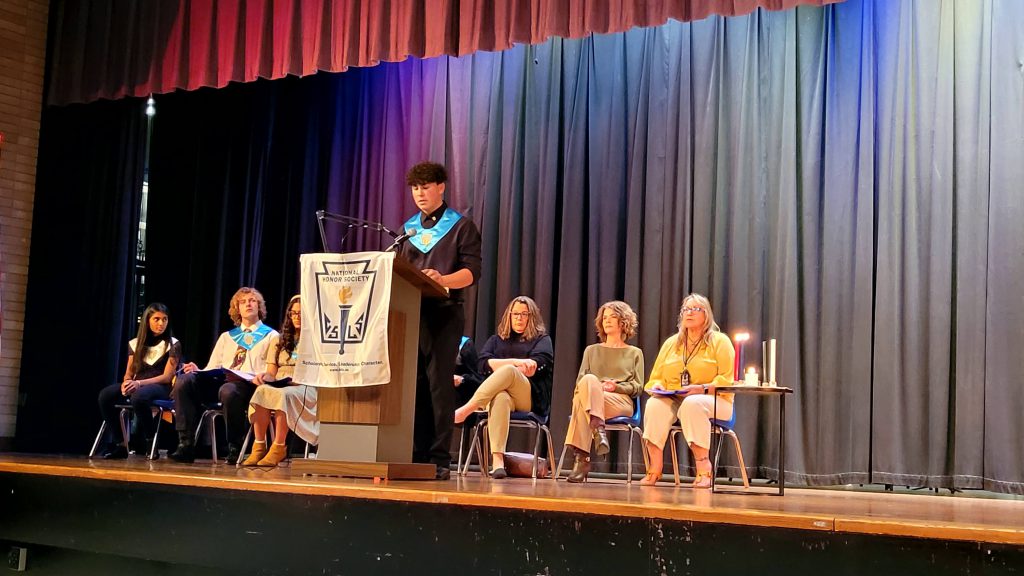 a student is at the podium onstage, speaking