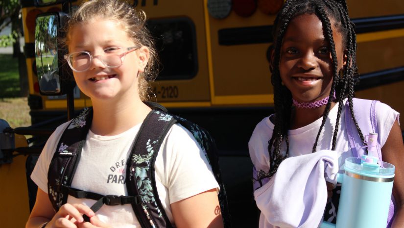 two students are smiling