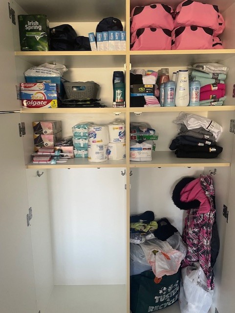 a close up of the Care Closet. It's a shelving unit filled with toiletries and clothing