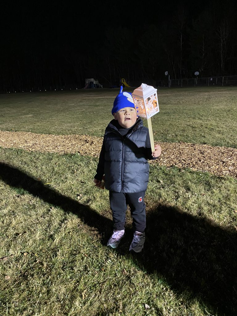 A student holds up a lantern during the lantern walk