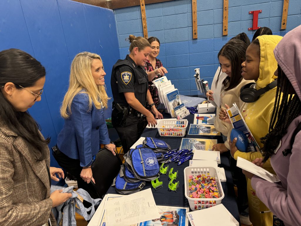 students are speaking to company representatives at a career fair 