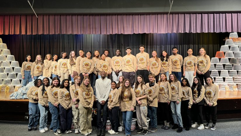 The Monticello High School Food Drive Committee is posing among the food they collected