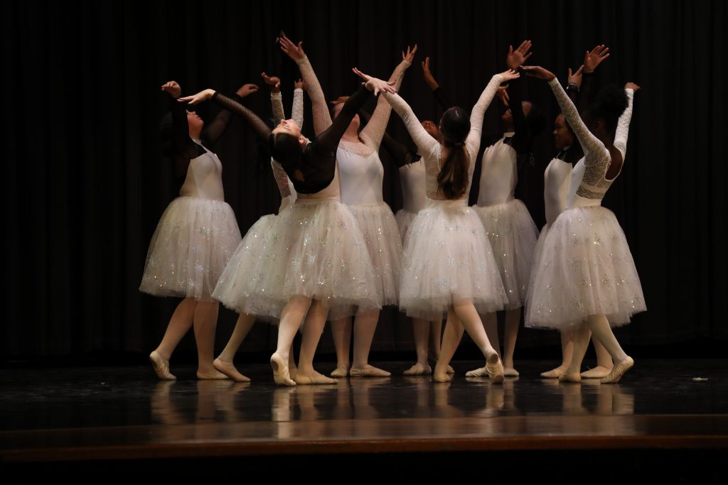 a circle of ballerinas performing on stage