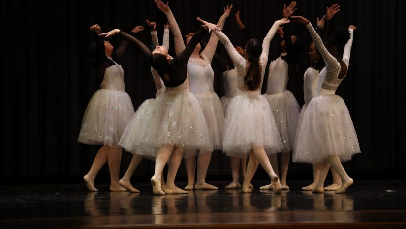 a circle of ballerinas performing on stage