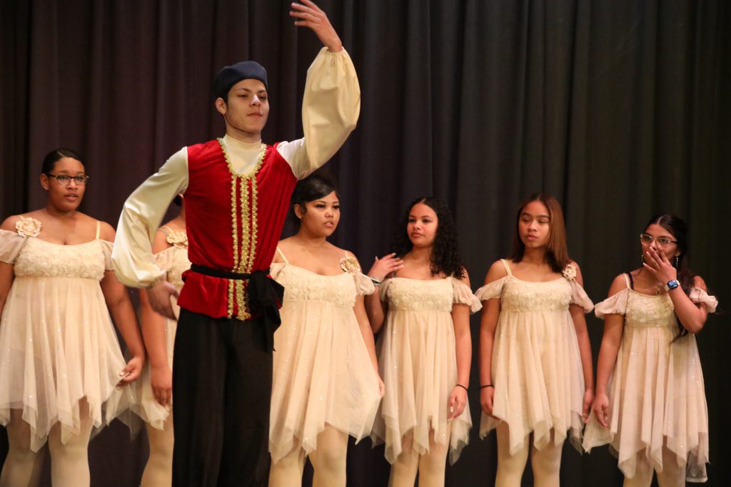 a dance student is taking a bow on stage