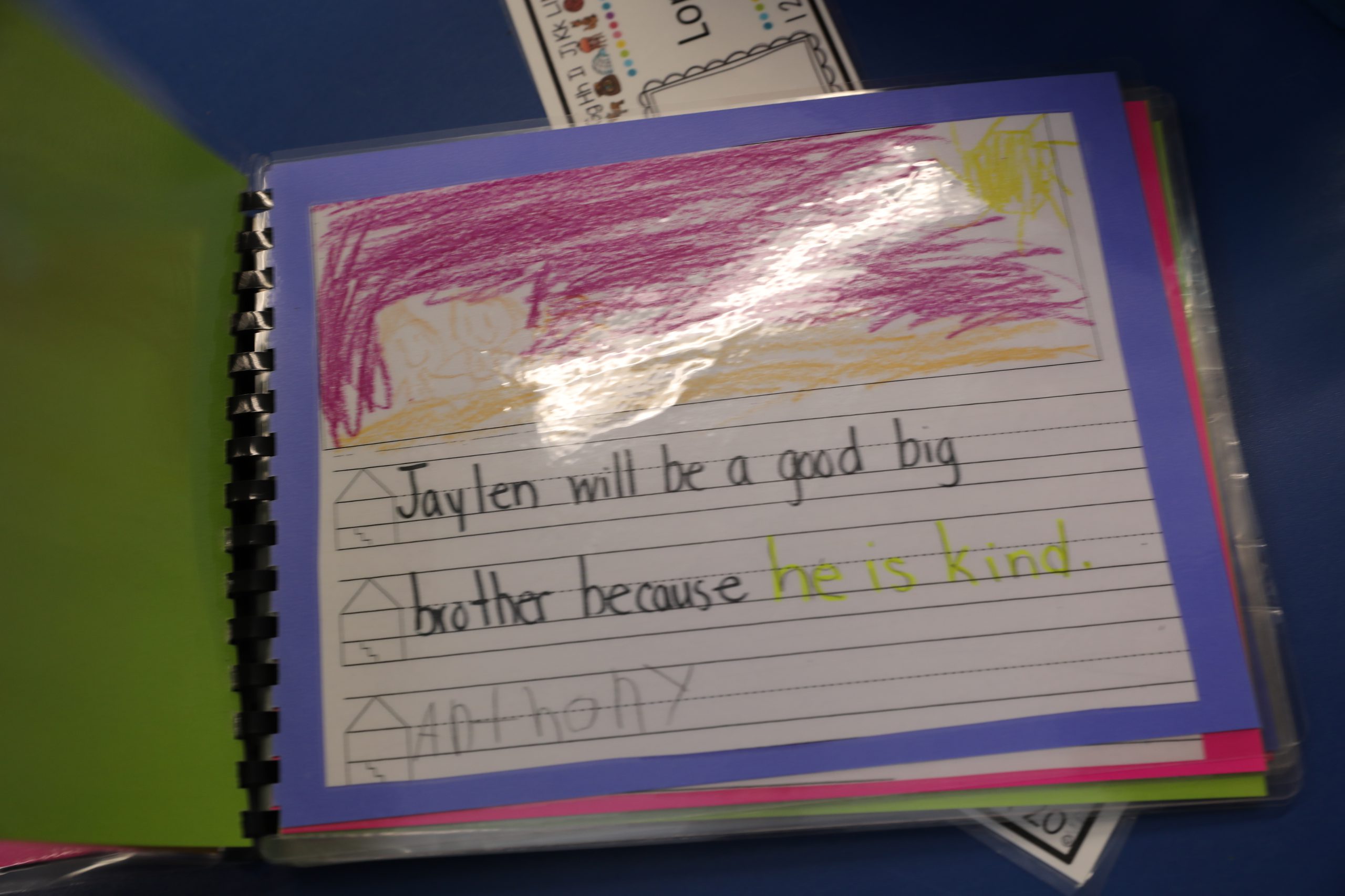 photo of a page from the book Jaylens classmates created. in child's handwriting, the page reads "Jaylen will be a big brother because he is kind."