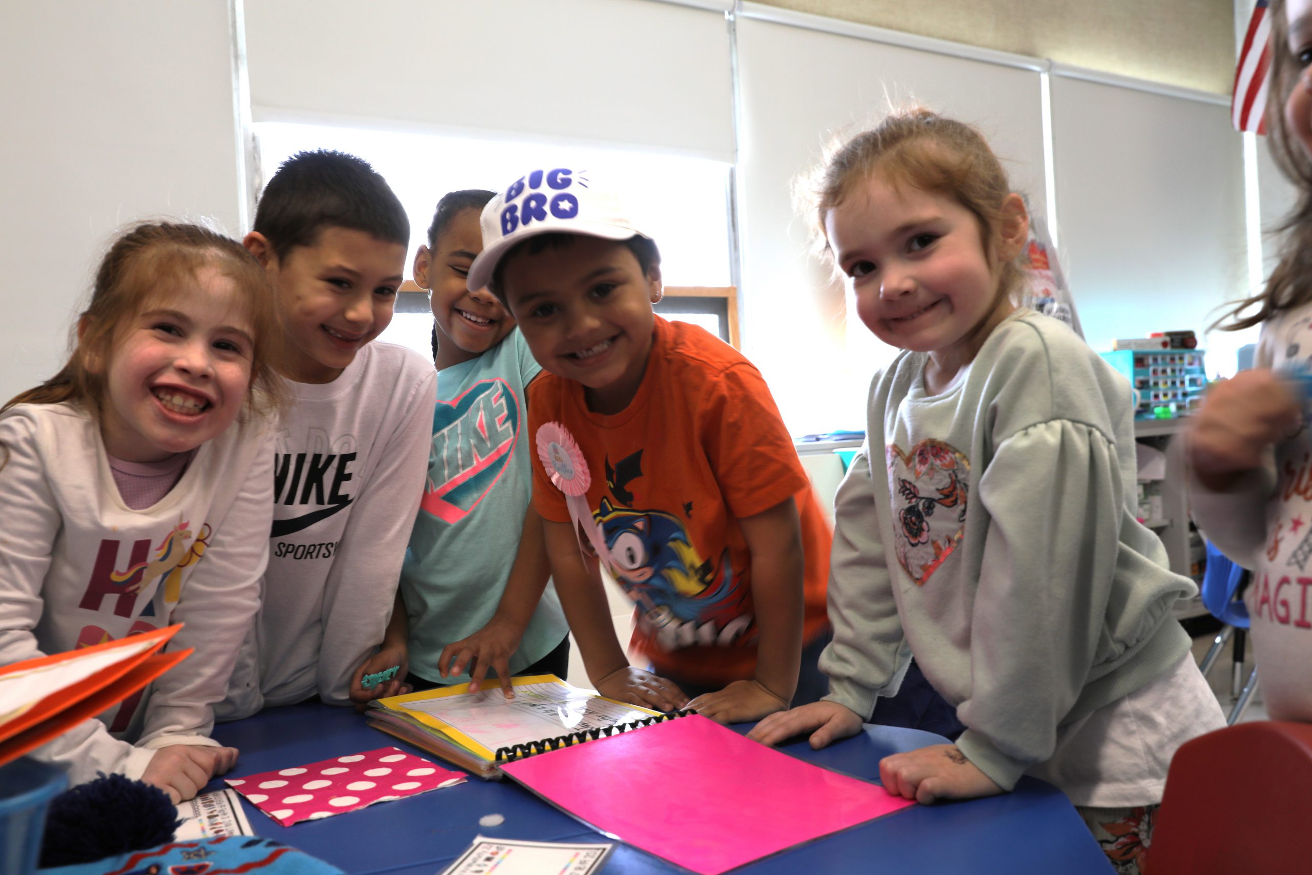 Jaylen and several classmates are looking up at the camera and smiling. 