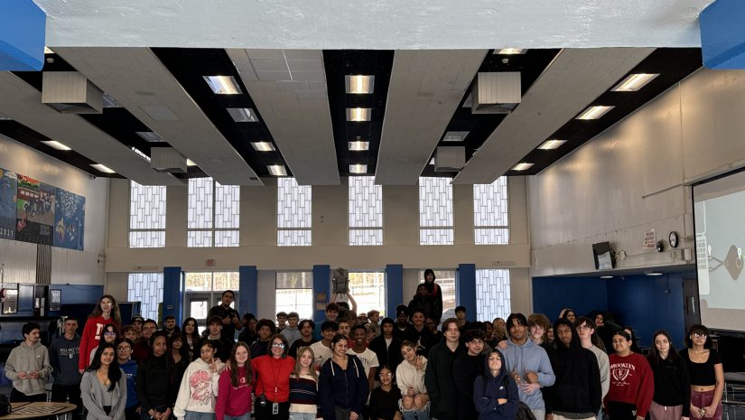 a group of students are posing in the cafeteria