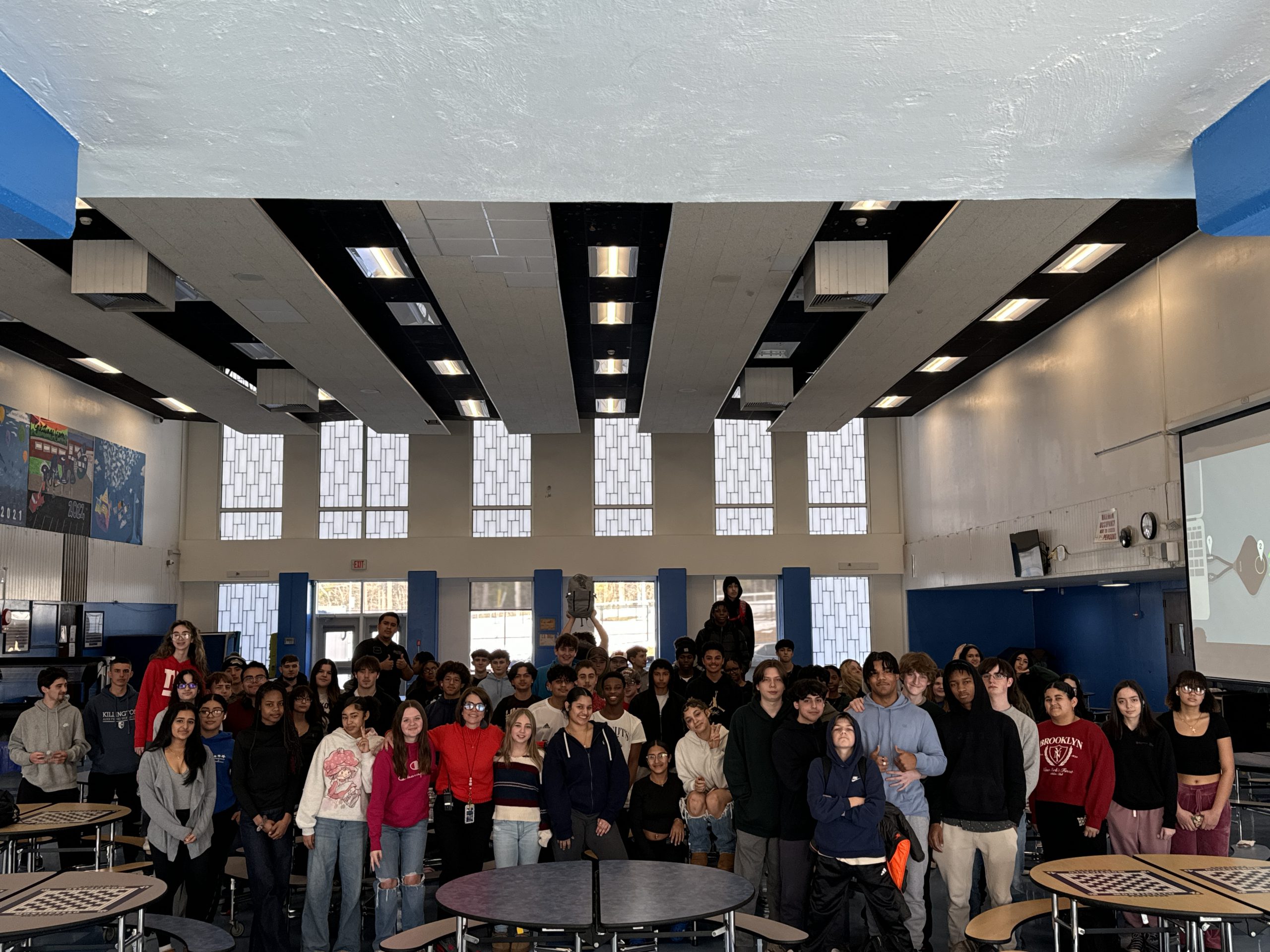 a group of students are posing in the cafeteria