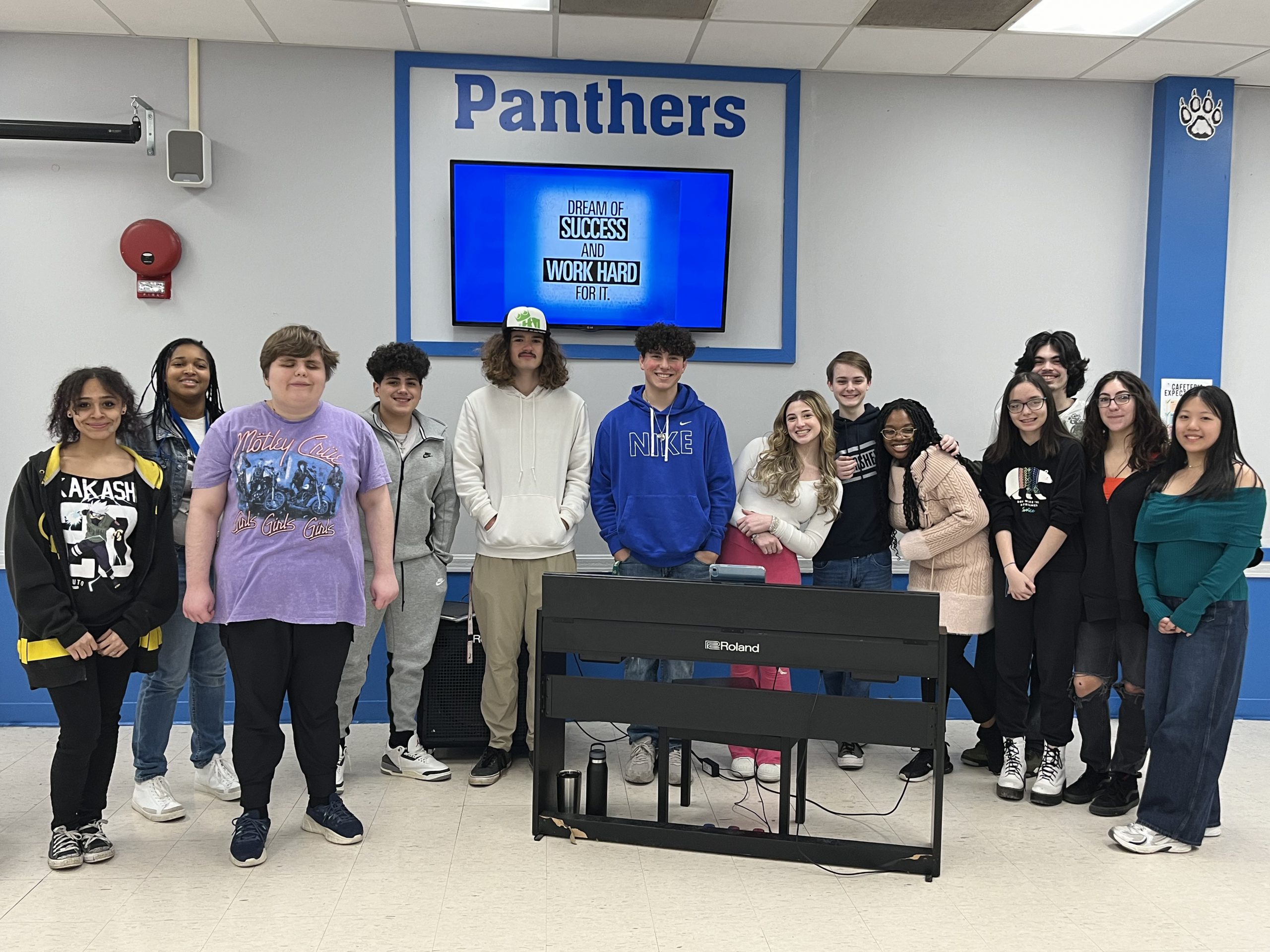 a group of students are posing for the camera. 